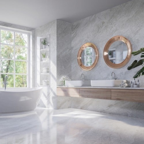 A marble bathroom with double sinks and a soaking tub