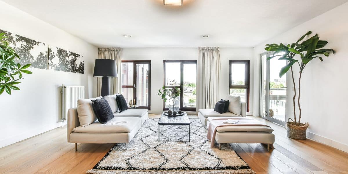 A bright living room with sofas and large windows